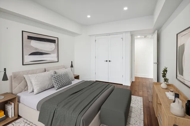 a bedroom with a bed and a painting on the wall