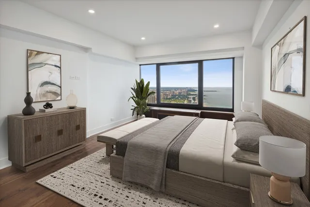 a bedroom with a bed and a large window