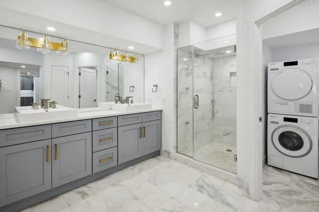 a spacious bathroom with a shower sink mirror and toilet
