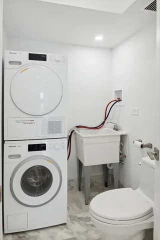 a bathroom with a toilet a sink and a mirror