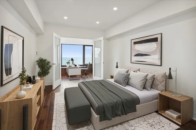 a bedroom with a large bed couch and a flat tv screen