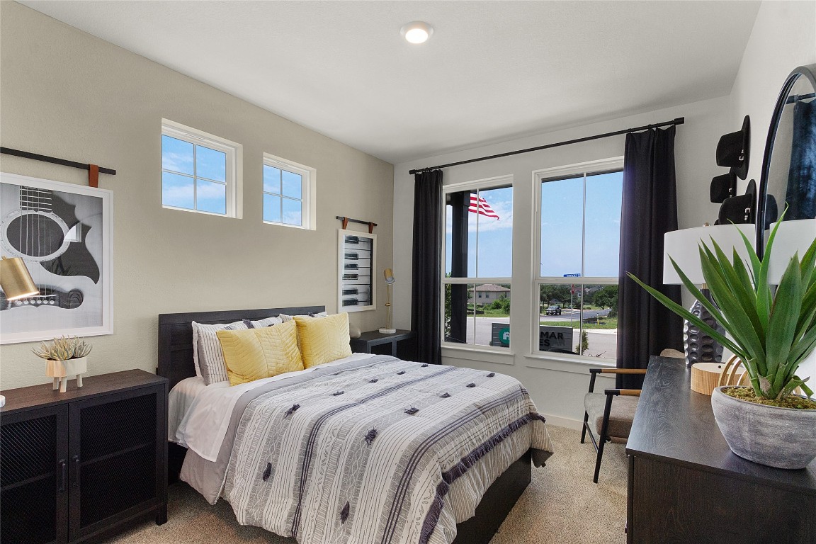 120 Pipe Cactus Pass Georgetown, TX 78633 - Photo 18 of 35 a bedroom with a large bed and a potted plant on the dresser