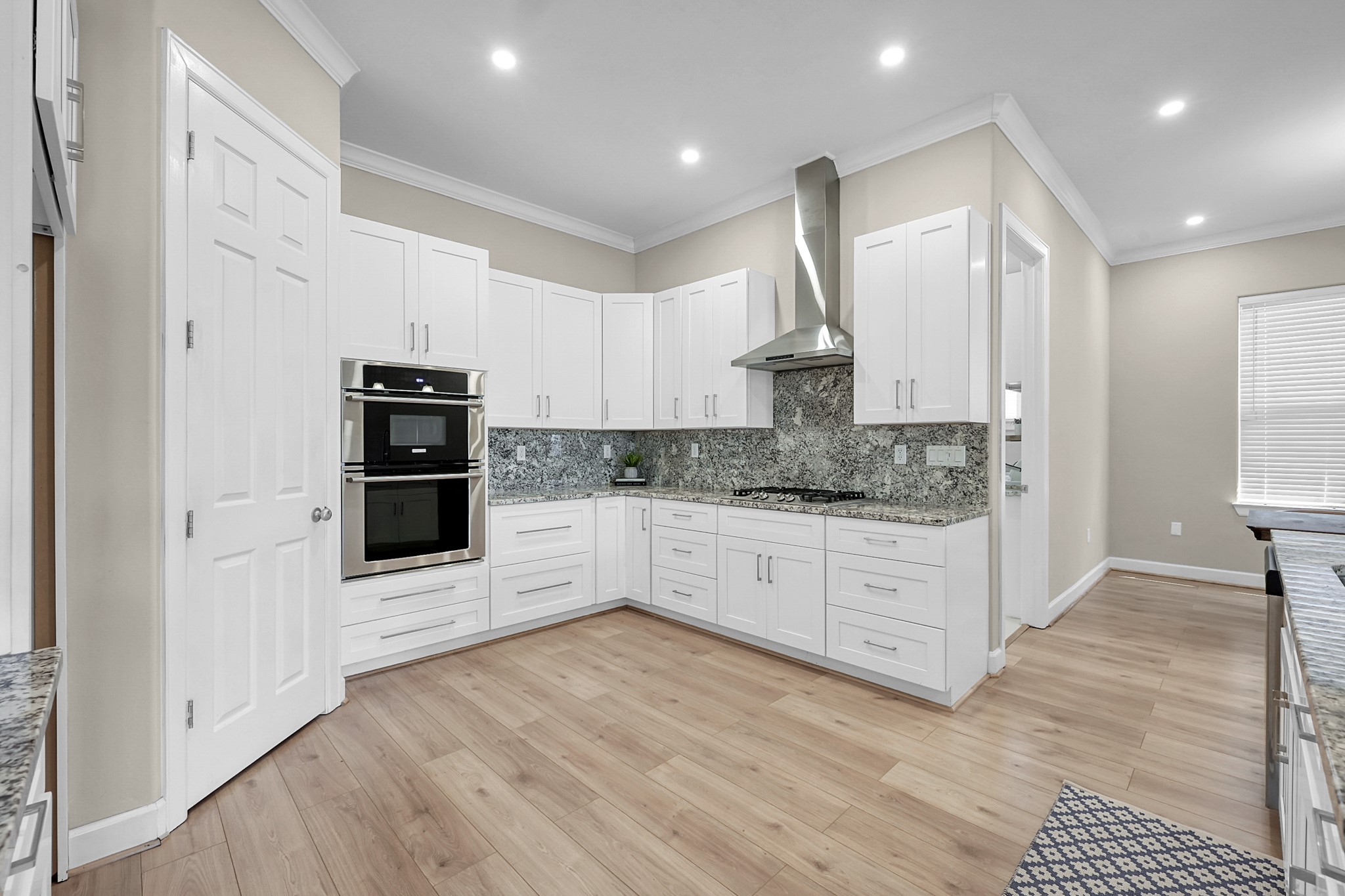 121 Bermuda Circle Montgomery, TX 77356 - Photo 15 of 44 a kitchen with stainless steel appliances kitchen island granite countertop a refrigerator oven a sink and white cabinets with wooden floor