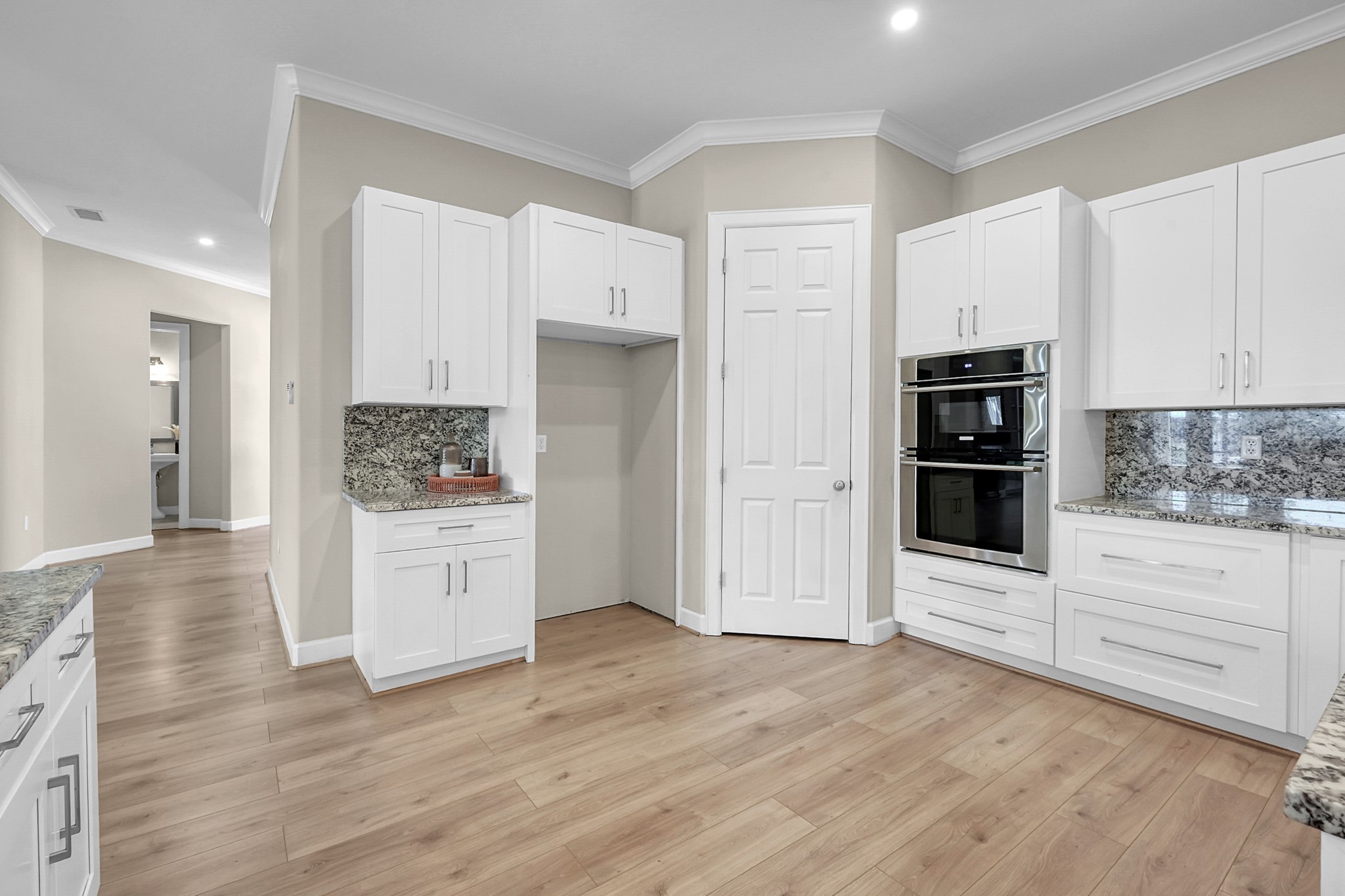 121 Bermuda Circle Montgomery, TX 77356 - Photo 16 of 44 a kitchen with white cabinets and stainless steel appliances