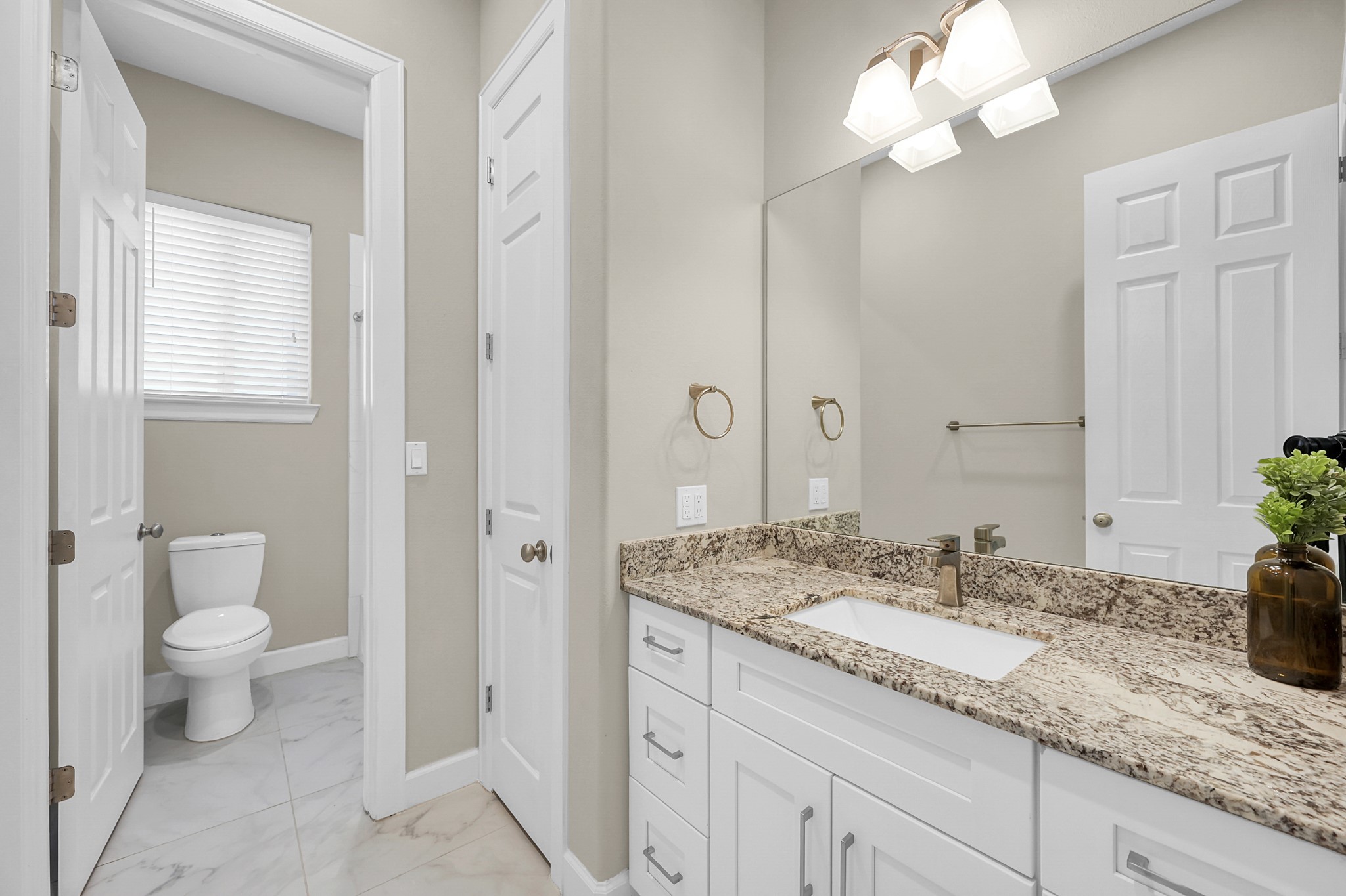 121 Bermuda Circle Montgomery, TX 77356 - Photo 32 of 44 a bathroom with a granite countertop sink a toilet and a mirror