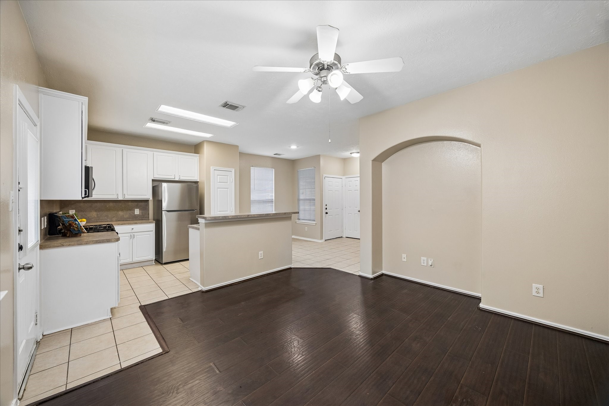 14334 Fairbuff Lane Houston, TX 77014 - Photo 3 of 15 a view of a kitchen with wooden floor and stainless steel appliances