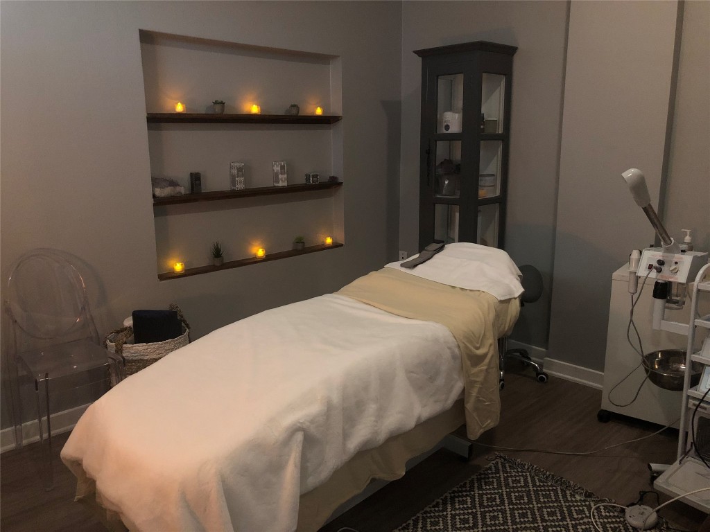 4361 South Congress Avenue, Unit 106 Austin, TX 78745 - Photo 4 of 11 a bed sitting in a bedroom next to a window with wooden floor