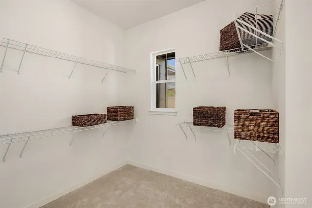 a view of storage and utility room with racks on the wall