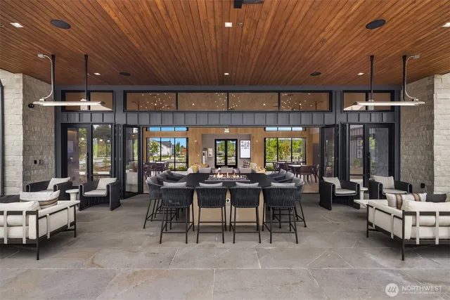 a view of a big room with dining table and chairs