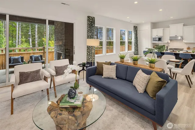 a living room with furniture and floor to ceiling windows
