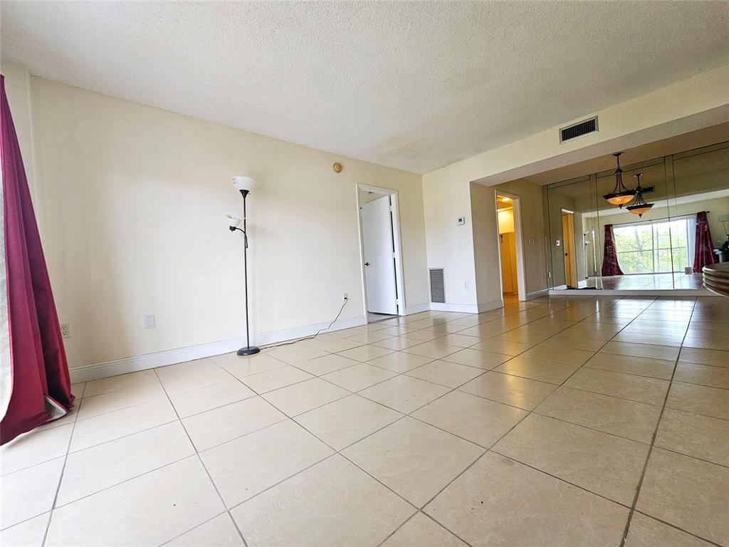 4172 Inverrary Drive, Unit 410 Lauderhill, FL 33319 - Photo 11 of 23 a view of a livingroom with a furniture and a window