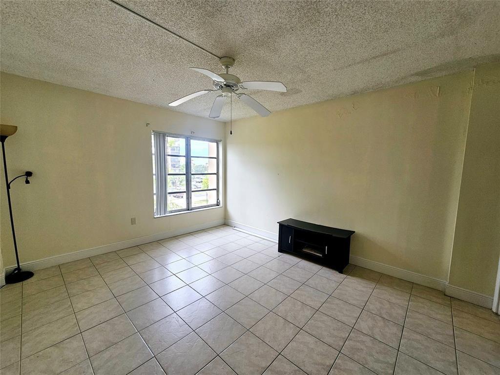 4172 Inverrary Drive, Unit 410 Lauderhill, FL 33319 - Photo 17 of 23 an empty room with windows and ceiling fan