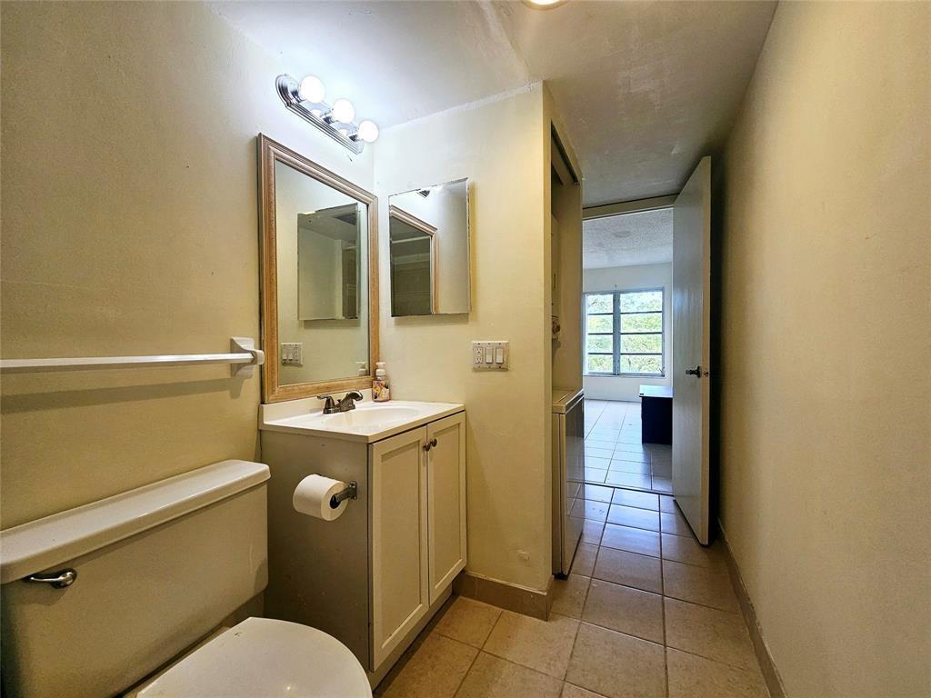 4172 Inverrary Drive, Unit 410 Lauderhill, FL 33319 - Photo 18 of 23 a bathroom with a sink toilet and shower