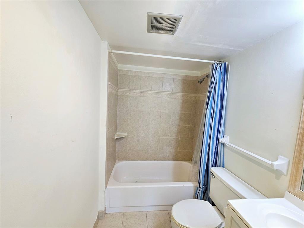 4172 Inverrary Drive, Unit 410 Lauderhill, FL 33319 - Photo 19 of 23 a bathroom with a toilet and a bath tub