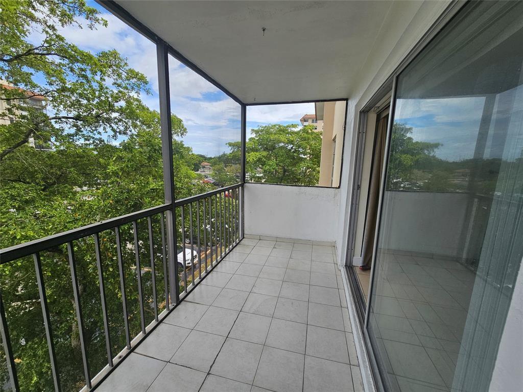 4172 Inverrary Drive, Unit 410 Lauderhill, FL 33319 - Photo 22 of 23 a view of a balcony with wooden floor and fence