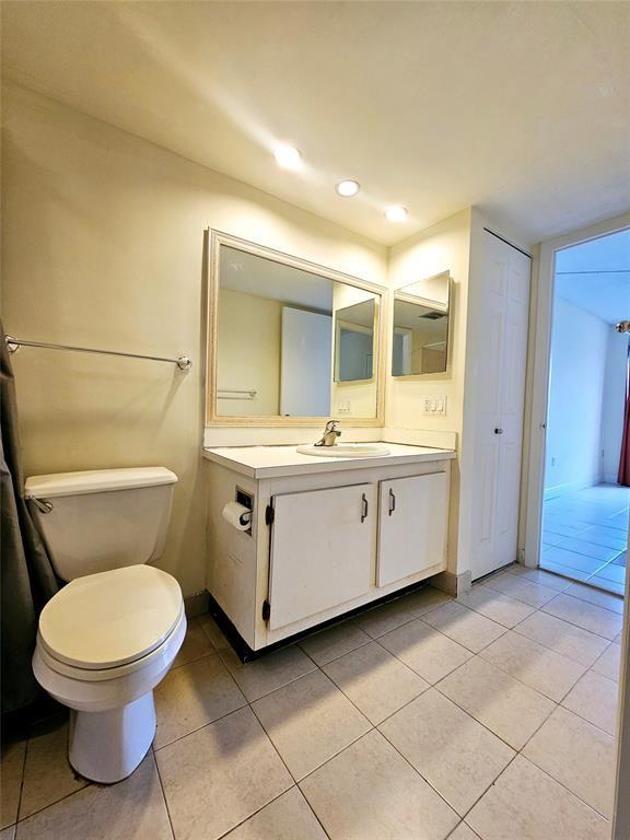 4172 Inverrary Drive, Unit 410 Lauderhill, FL 33319 - Photo 7 of 23 a bathroom with a toilet sink and mirror