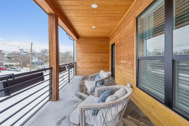 a roof deck with table and chairs and wooden floor