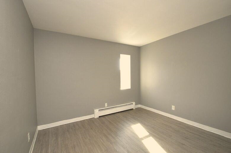 506 Main Street Marseilles, IL 61341 - Photo 7 of 8 an empty room with wooden floor and window