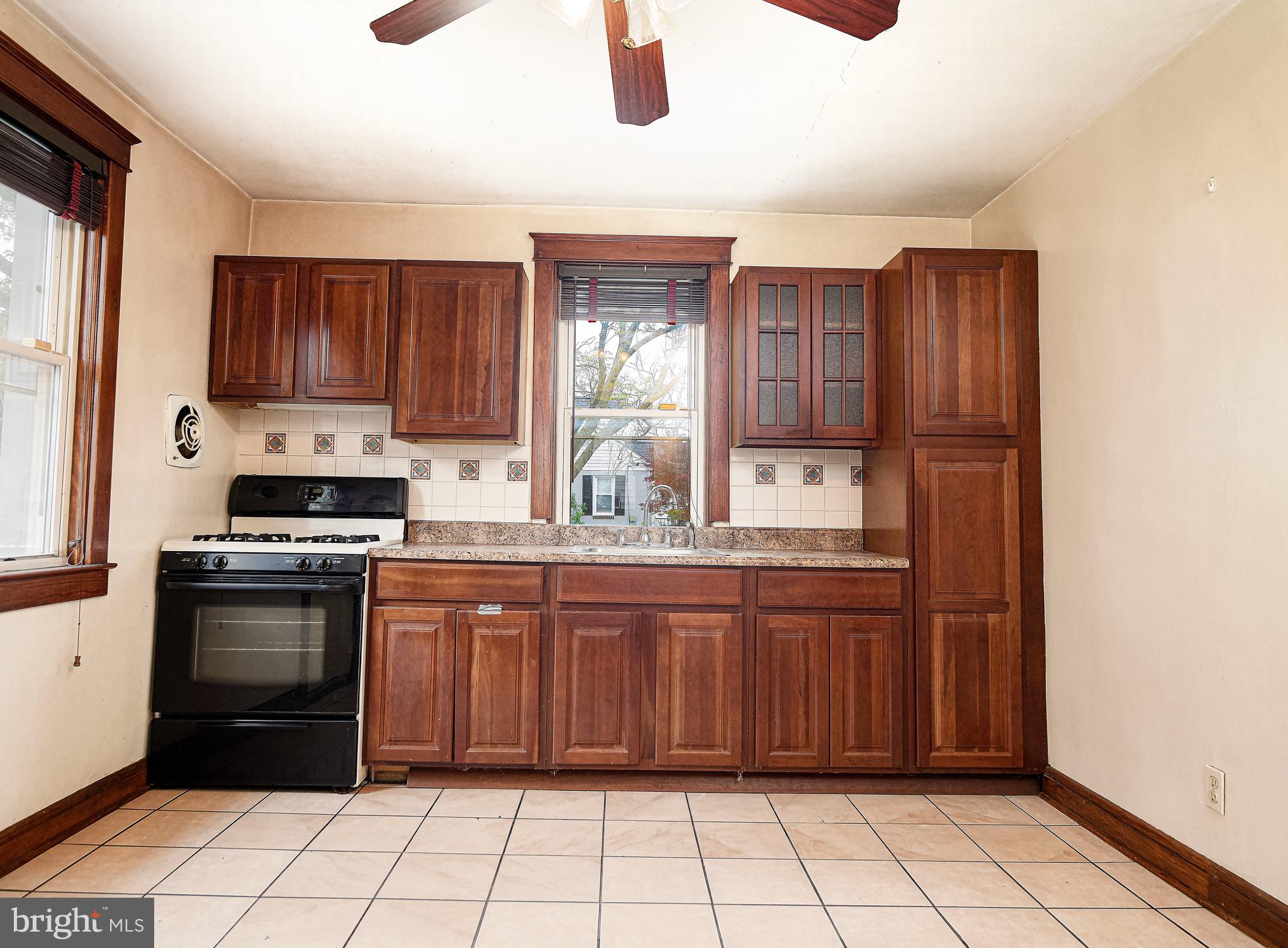 3608 East Joppa Road Baltimore, MD 21234 - Photo 12 of 29 Dark maple cabinets, tiled floor & backsplash