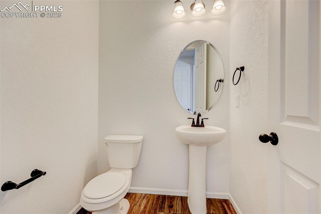 6237 Bodacious Circle Colorado Springs, CO 80923 - Photo 15 of 33 Bathroom with toilet and wood finished floors