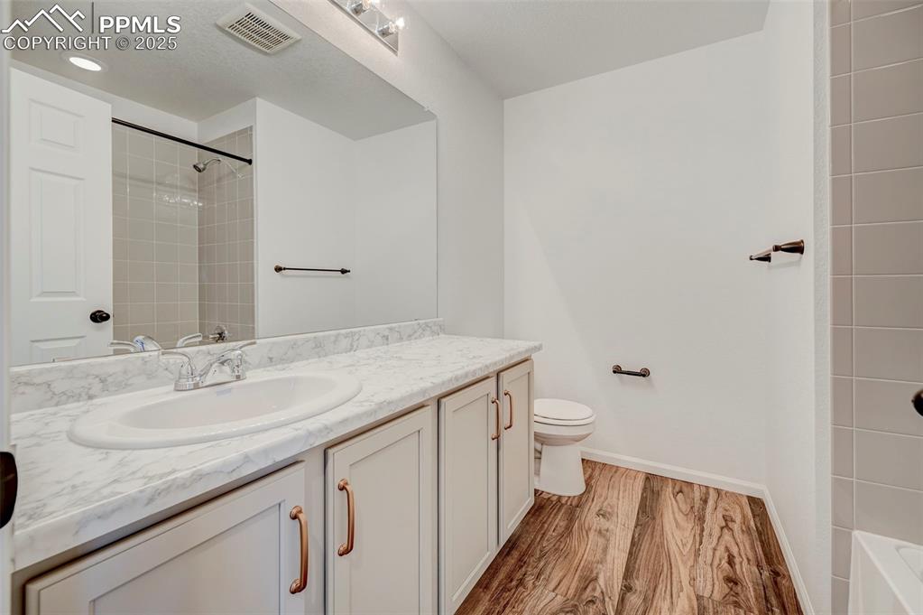 6237 Bodacious Circle Colorado Springs, CO 80923 - Photo 26 of 33 Bathroom featuring vanity and wood finished floors