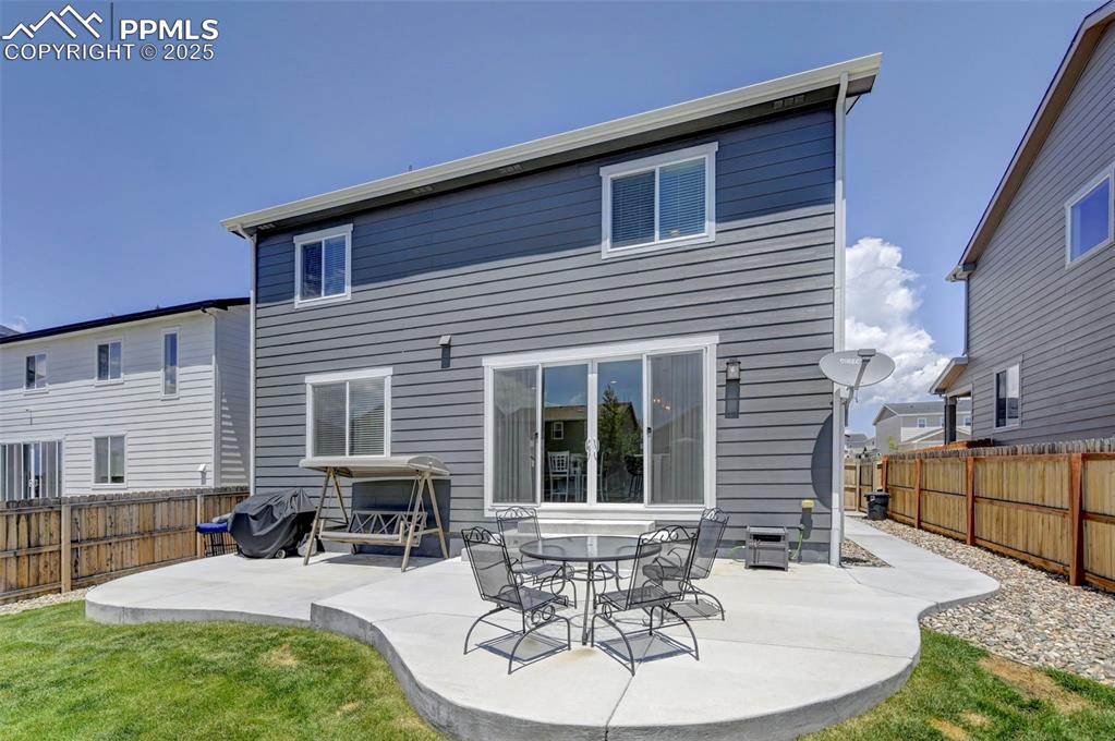 6237 Bodacious Circle Colorado Springs, CO 80923 - Photo 29 of 33 Back of house featuring a patio and a fenced backyard