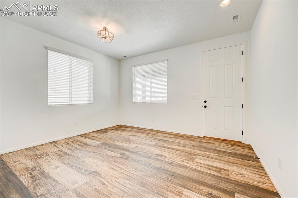6237 Bodacious Circle Colorado Springs, CO 80923 - Photo 3 of 33 Unfurnished room featuring light wood-style flooring and recessed lighting