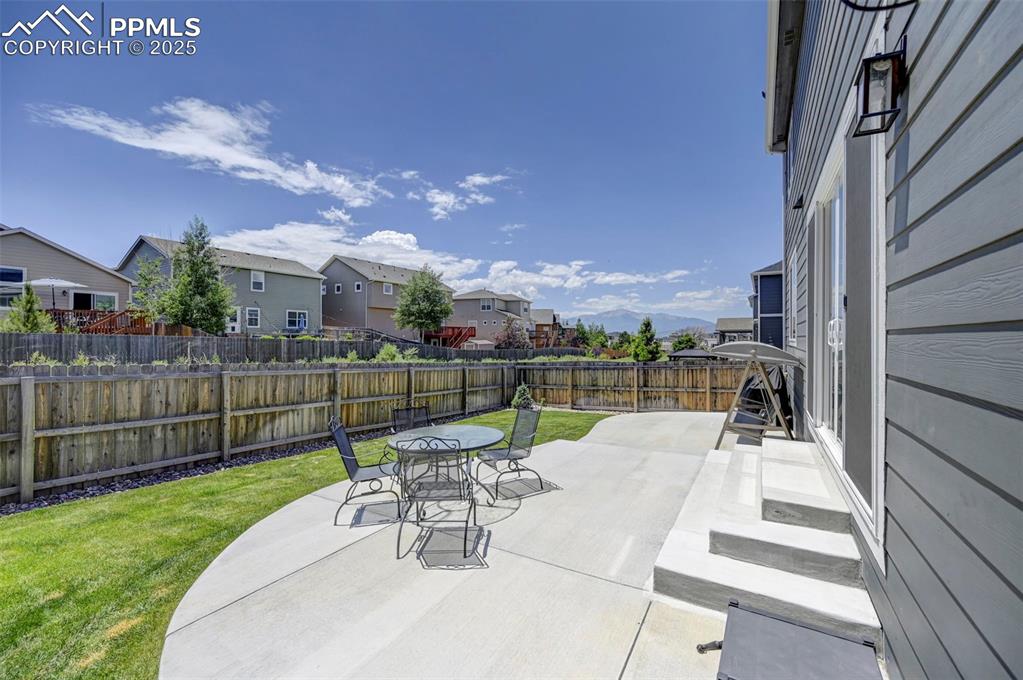 6237 Bodacious Circle Colorado Springs, CO 80923 - Photo 31 of 33 Fenced backyard featuring a residential view, a patio area, and outdoor dining area