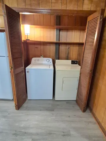 a view of a livingroom with furniture wooden floor and chandelier