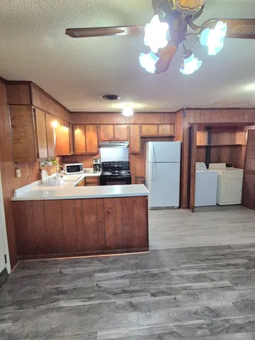 a kitchen with a stove a sink and a microwave