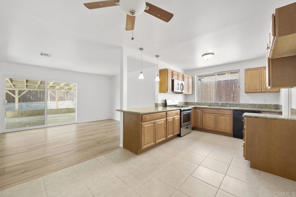 3129 Glenn Road Oceanside, CA 92056 - Photo 11 of 31 a large kitchen with granite countertop a large counter top space a sink stainless steel appliances and cabinets