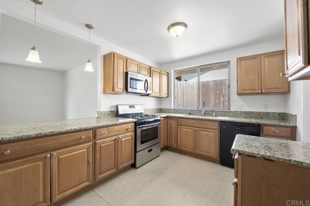3129 Glenn Road Oceanside, CA 92056 - Photo 12 of 31 a kitchen with granite countertop cabinets stainless steel appliances a sink and a window