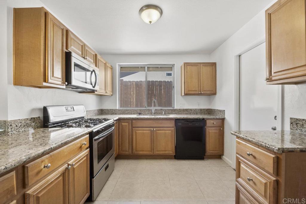3129 Glenn Road Oceanside, CA 92056 - Photo 13 of 31 a kitchen with stainless steel appliances granite countertop a stove sink and cabinets