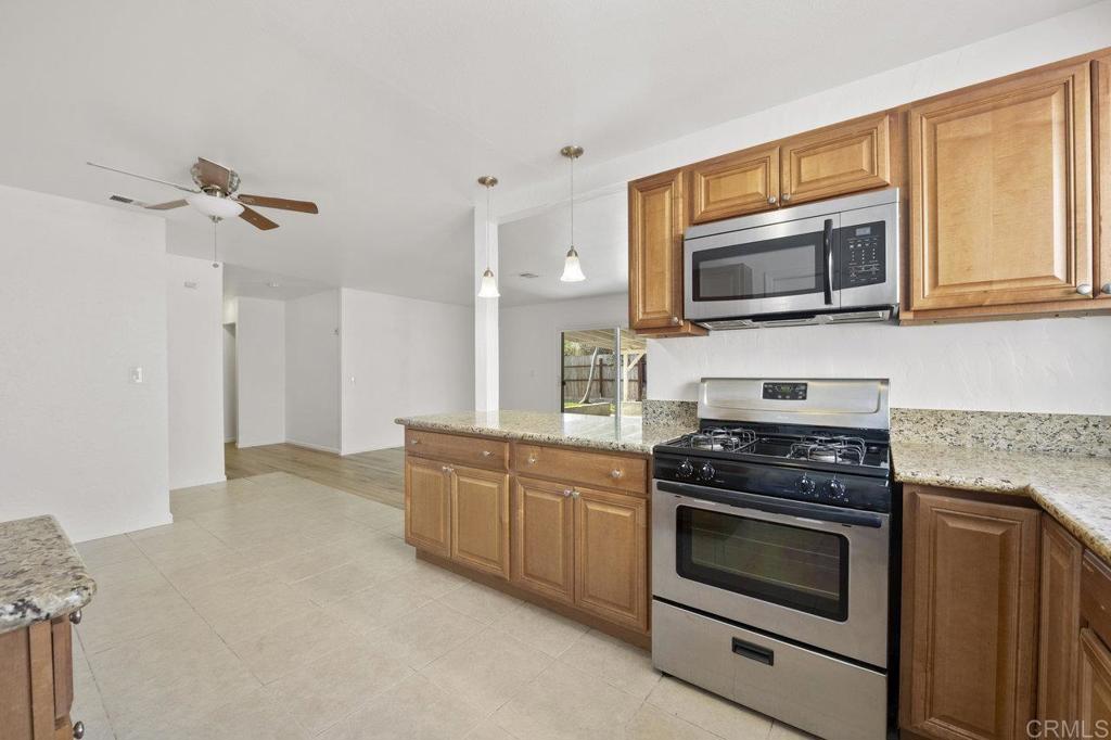 3129 Glenn Road Oceanside, CA 92056 - Photo 14 of 31 a kitchen with granite countertop a stove top oven and cabinets