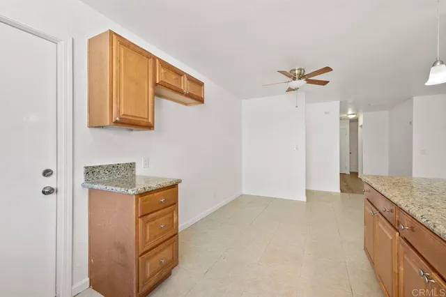 a kitchen with stainless steel appliances granite countertop a sink and a refrigerator