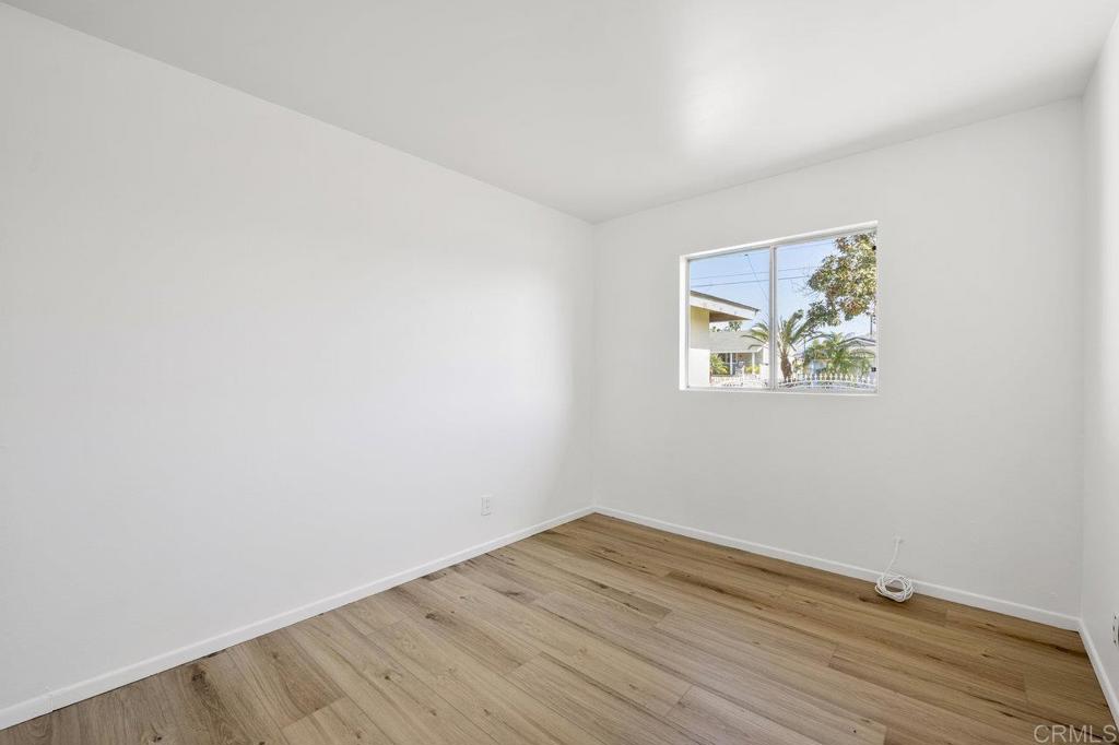 3129 Glenn Road Oceanside, CA 92056 - Photo 16 of 31 an empty room with wooden floor and window