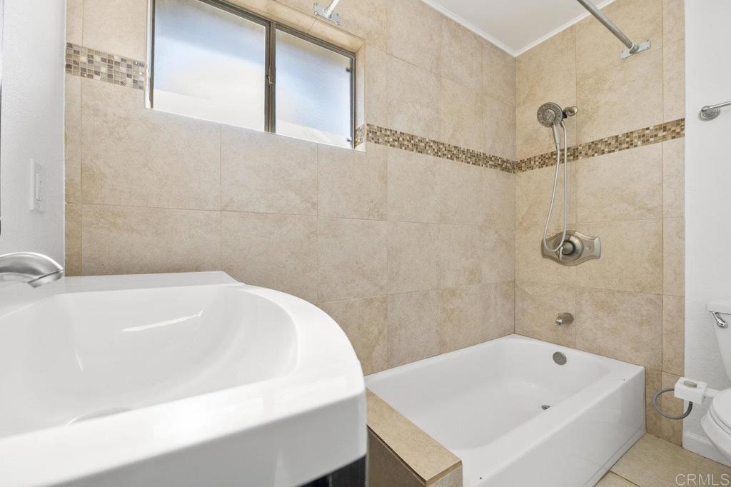 3129 Glenn Road Oceanside, CA 92056 - Photo 21 of 31 a bathroom with a white bath tub and a shower