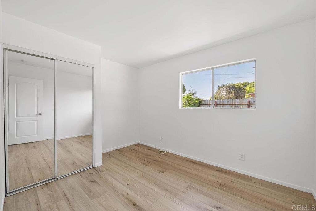 3129 Glenn Road Oceanside, CA 92056 - Photo 23 of 31 an empty room with wooden floor and closet