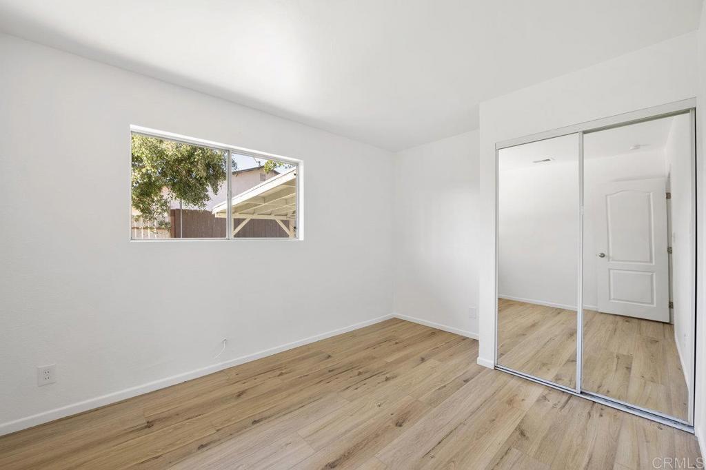 3129 Glenn Road Oceanside, CA 92056 - Photo 24 of 31 an empty room with wooden floor and windows