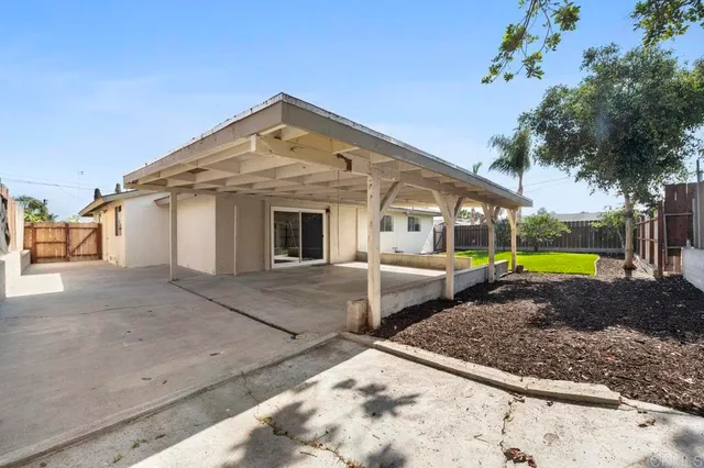 a view of a house with backyard and swimming pool