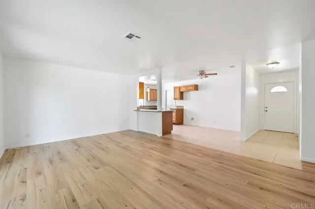 a view of a kitchen with wooden floor and window