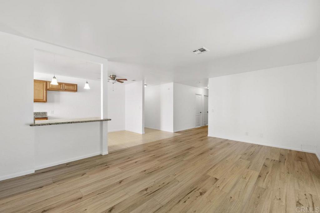 3129 Glenn Road Oceanside, CA 92056 - Photo 8 of 31 a view of an empty room with wooden floor and a window