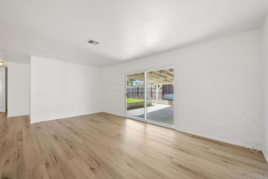 3129 Glenn Road Oceanside, CA 92056 - Photo 9 of 31 wooden floor in an empty room with a window