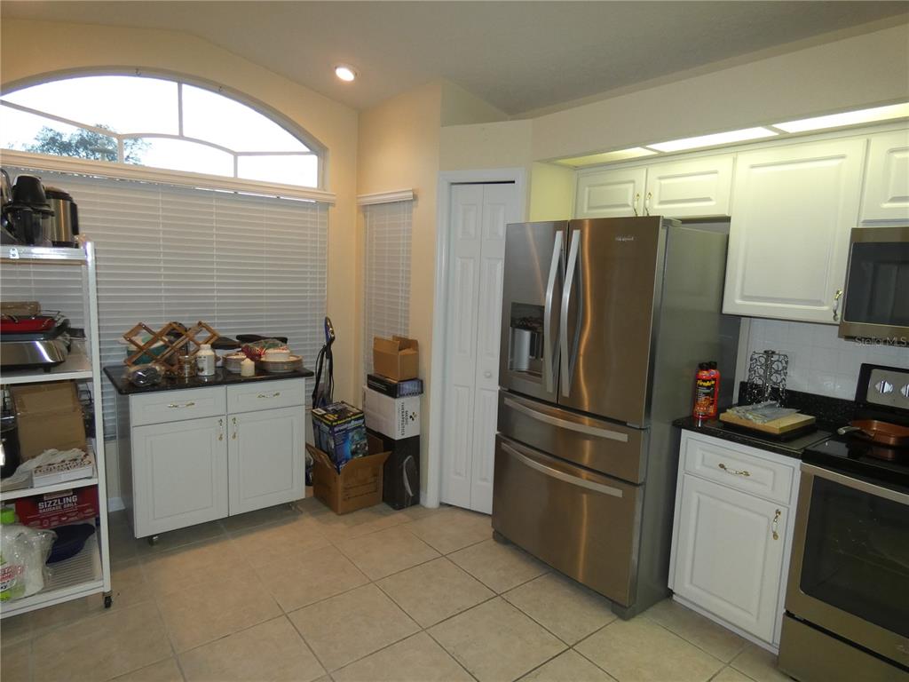 13541 Knotty Lane Hudson, FL 34669 - Photo 11 of 32 a kitchen with a refrigerator and a sink