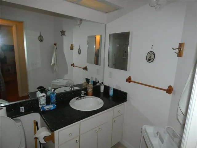 a bathroom with a sink double vanity granite and a mirror