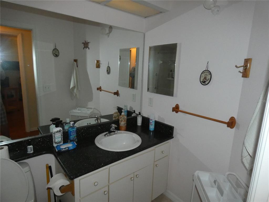 13541 Knotty Lane Hudson, FL 34669 - Photo 20 of 32 a bathroom with a sink double vanity granite and a mirror