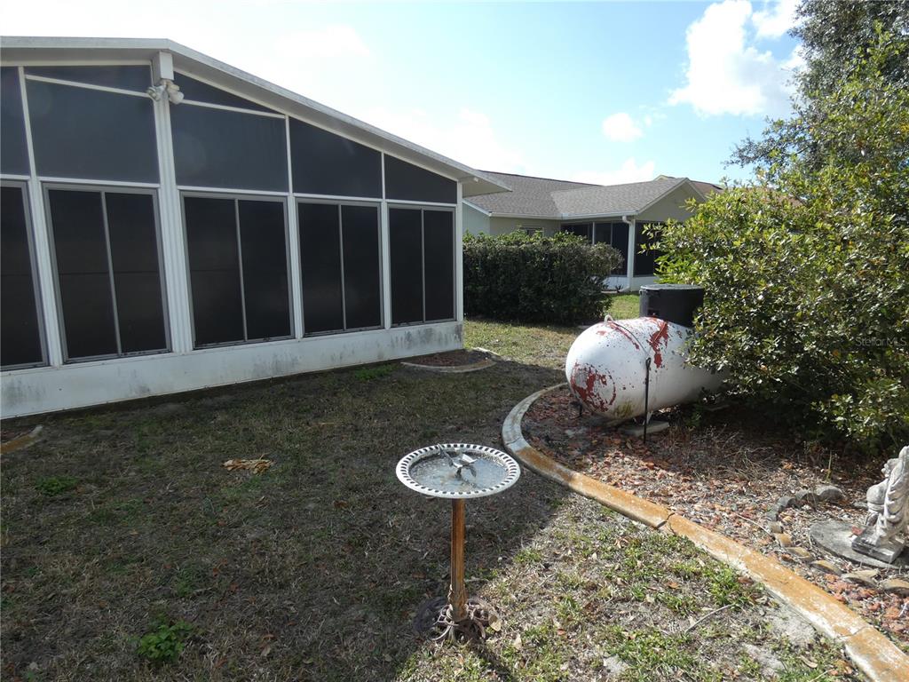 13541 Knotty Lane Hudson, FL 34669 - Photo 26 of 32 a view of a backyard with table and chairs