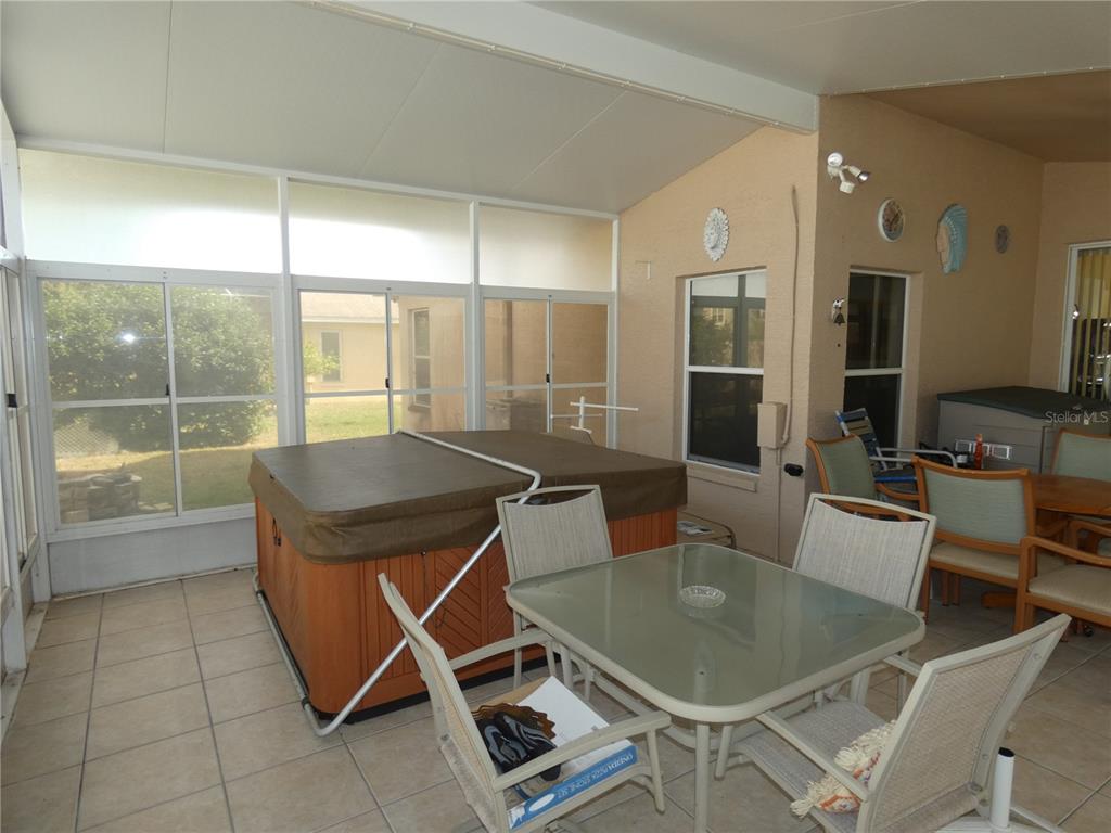 13541 Knotty Lane Hudson, FL 34669 - Photo 9 of 32 a kitchen with a table chairs and refrigerator