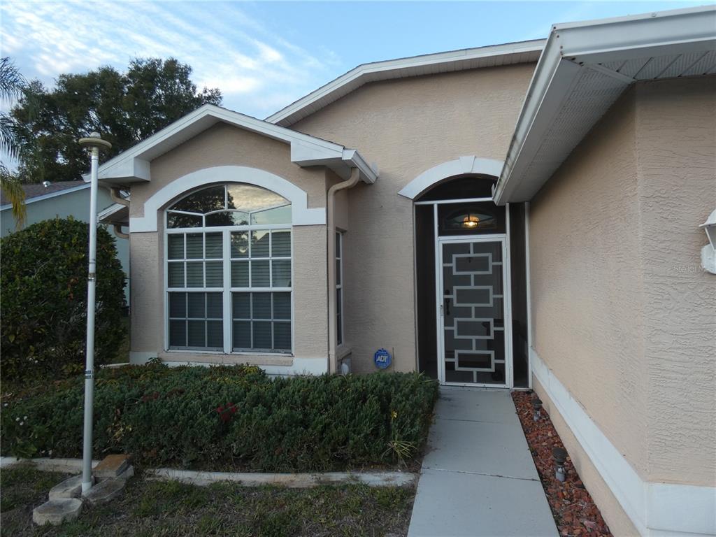 13541 Knotty Lane Hudson, FL 34669 - Photo 10 of 32 a front view of a house with a yard