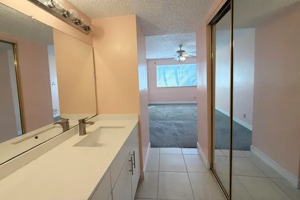 a bathroom with a sink shower and a mirror